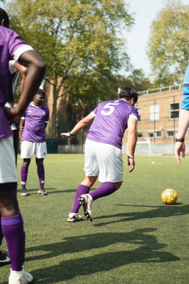 A player from Fair Shot FC runs towards a football.
