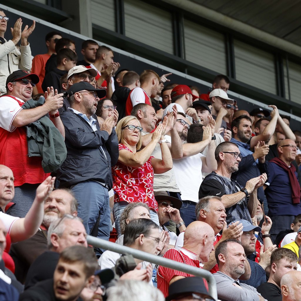 Rotherham United fans cheering from the stands of the New York Stadium
