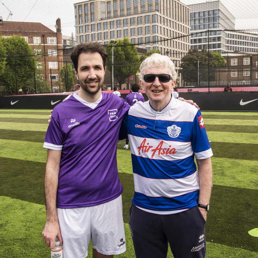 Two QPR FC fans pose together for a photo