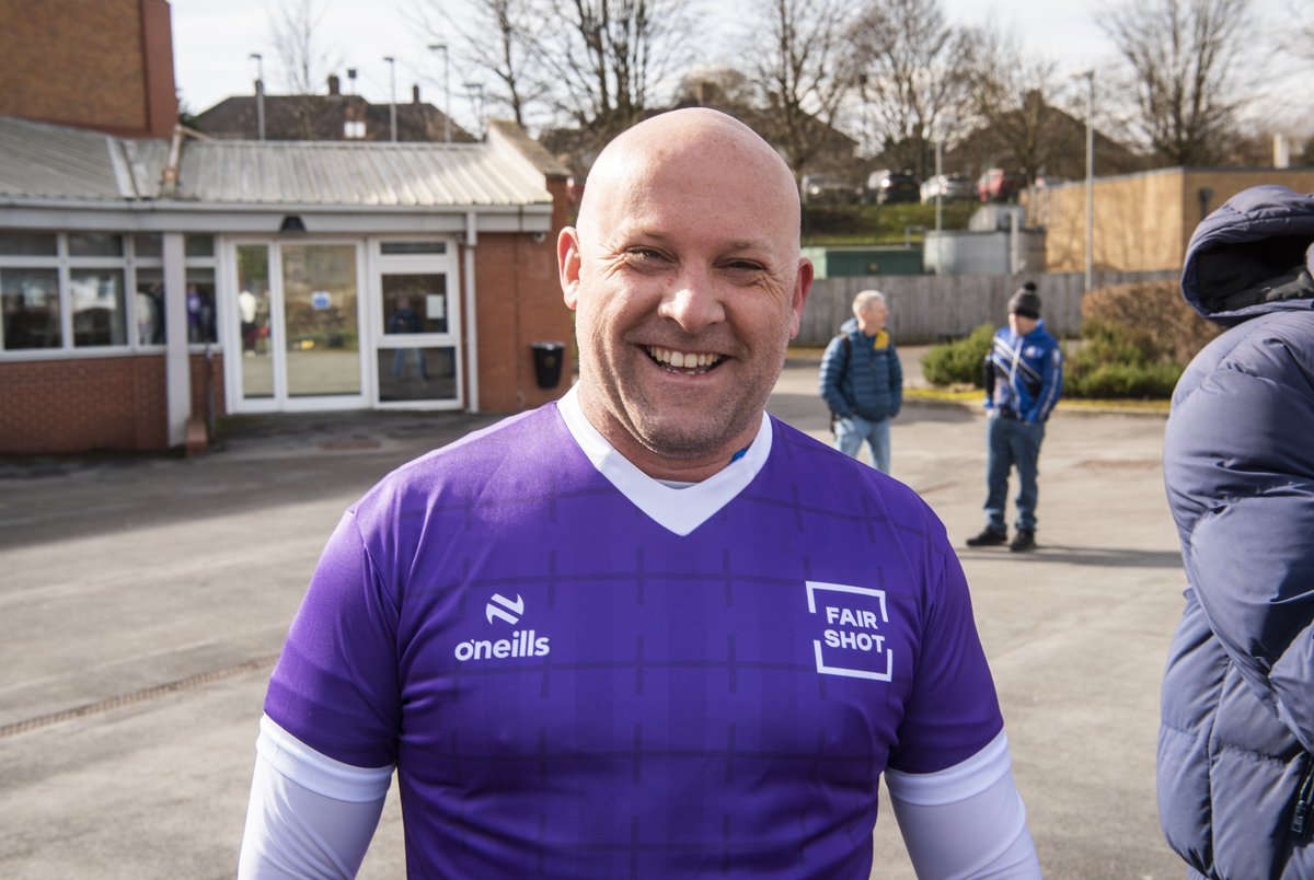 A Sheffield Wednesday FC fan wears Fair Shot FC's purple football shirt