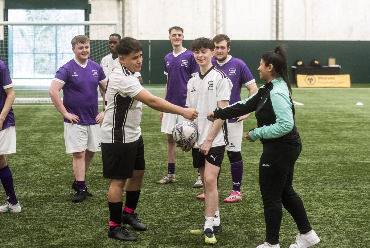 Diego fist bumps Nikki from Wolves Foundation at the Fair Shot matchday
