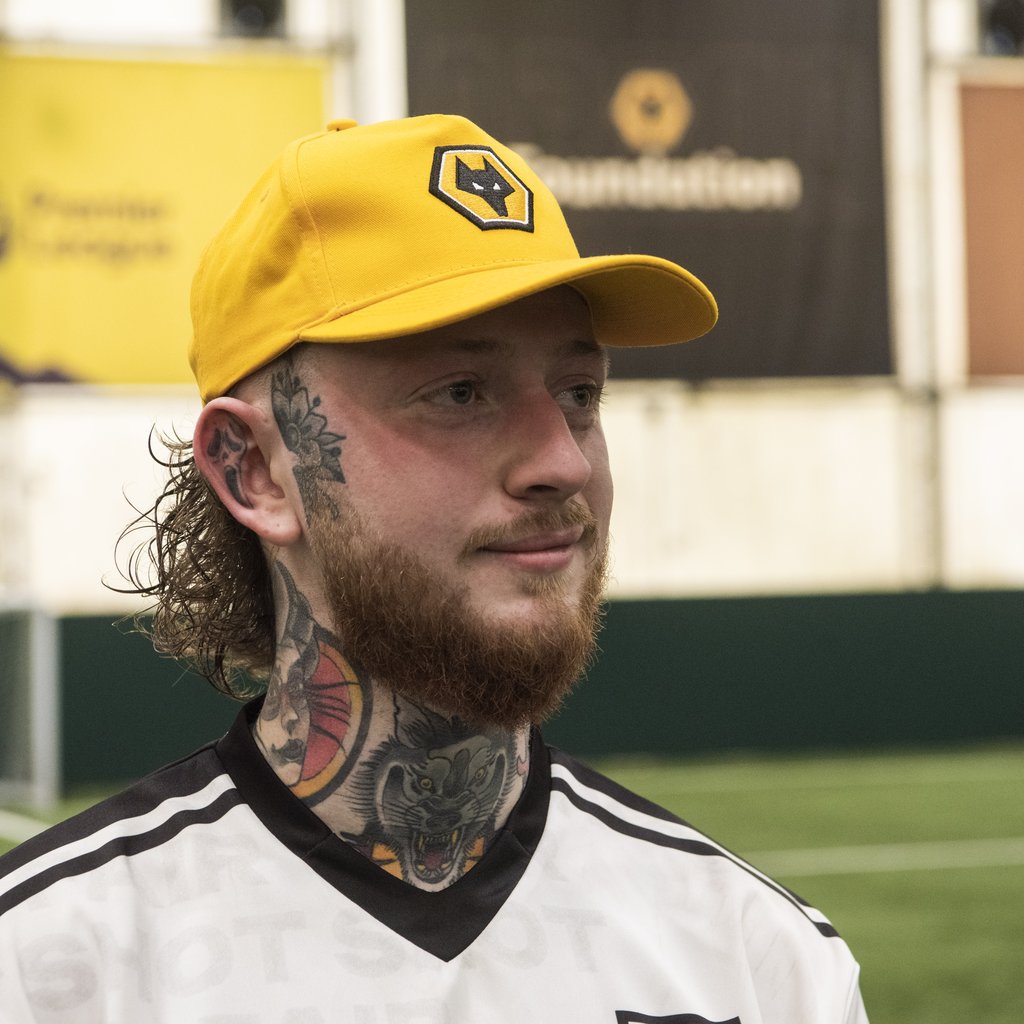 A fan wears a Wolves FC cap during the Fair Shot matchday