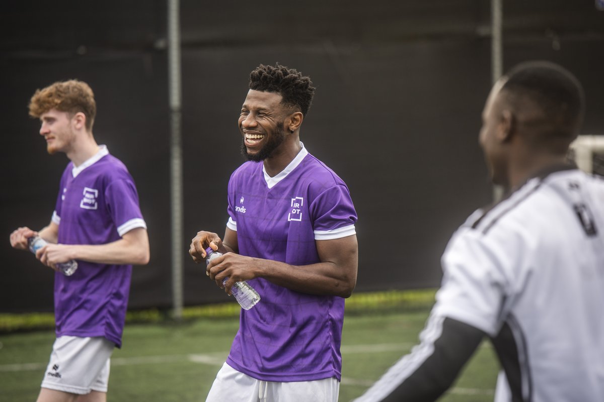 A football fan smiles whilst playing with Fair Shot FC