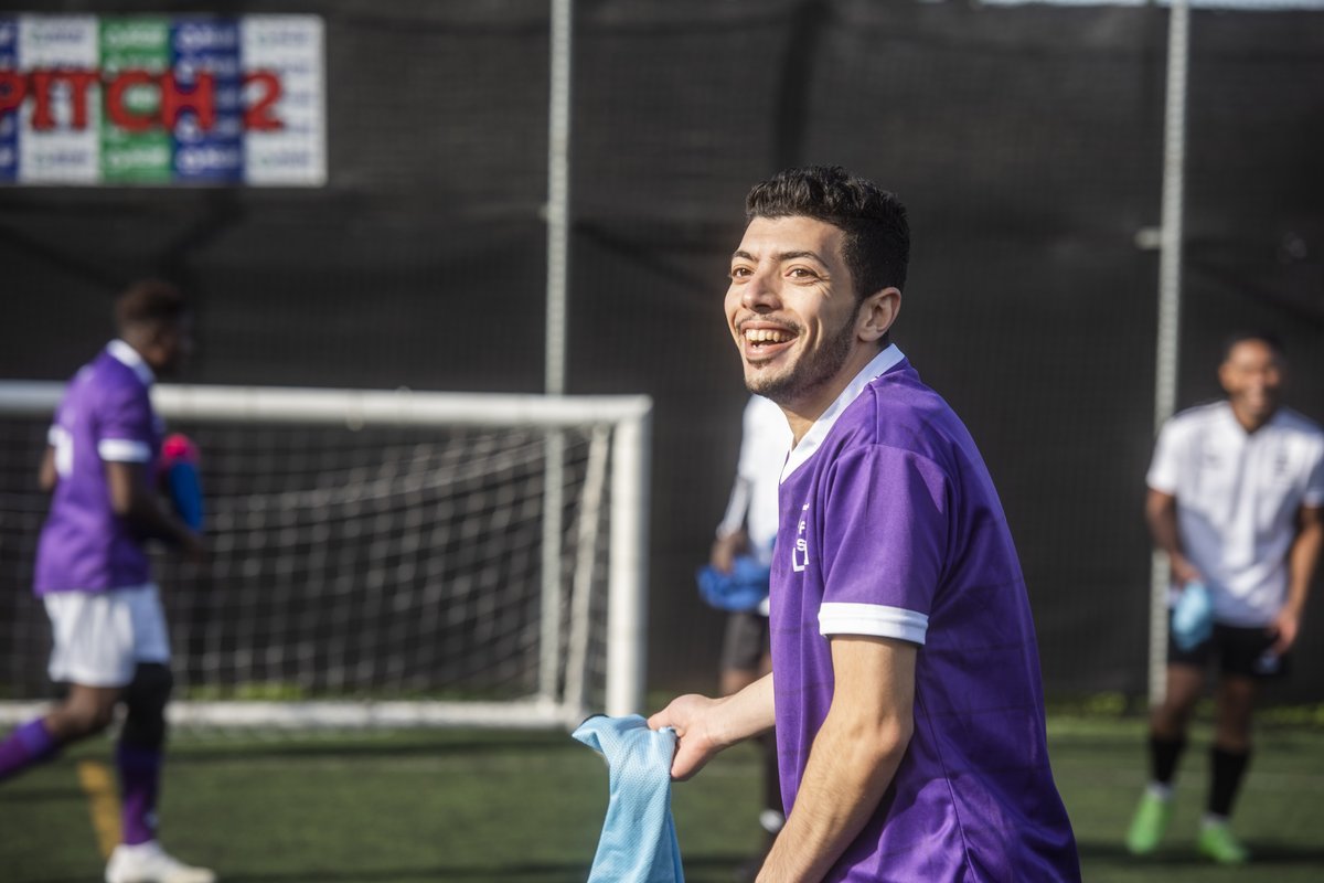 Manar, a Fair Shot FC player, smiles and laughs whilst on the pitch